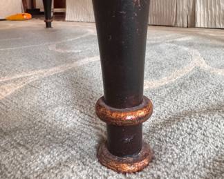 Ebonized Wood Coffee Table with Gold Tone Distressed Trim on Edge and Tapered Urn-Style Legs. Measures 28" x 48" x 19.5" H. Photo 5 of 5.