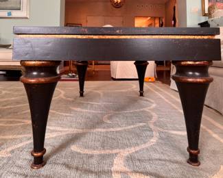Ebonized Wood Coffee Table with Gold Tone Distressed Trim on Edge and Tapered Urn-Style Legs. Measures 28" x 48" x 19.5" H. Photo 2 of 5.