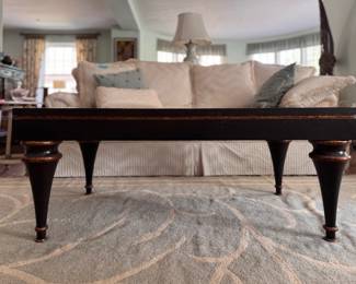 Ebonized Wood Coffee Table with Gold Tone Distressed Trim on Edge and Tapered Urn-Style Legs. Measures 28" x 48" x 19.5" H. Photo 1 of 5.