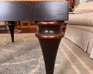 Ebonized Wood Coffee Table with Gold Tone Distressed Trim on Edge and Tapered Urn-Style Legs. Measures 28" x 48" x 19.5" H. Photo 4 of 5.