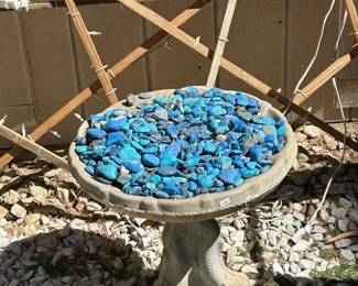Concrete bird bath with blue stones 