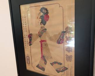 vintage framed piece of traditional Chinese shadow art, featuring an intricate figure inspired by opera puppets