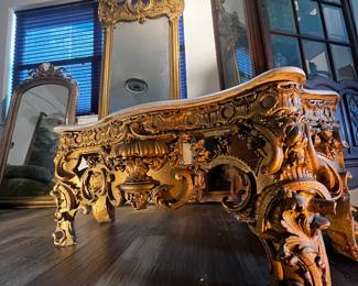 Pier mirror with carved console base, ornate Rococo and Baroque style carvings, giltwood finish, decorative entryway or mantel mirror, damage present.