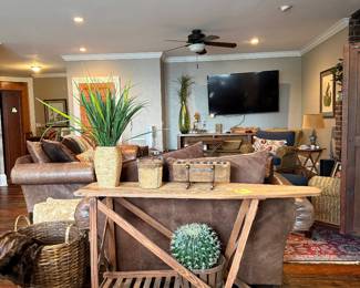 Downstairs, leather love seat, ironing board table, 60” tv, etc