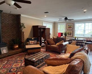 Downstairs leather love seat and couch, very nice rug, trunks, pillows, etc