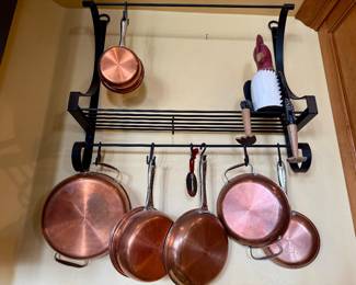 Copper pots on rack, wood chicken