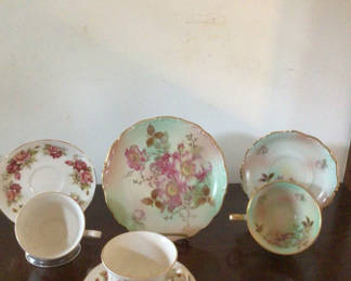 Lot 10: Floral porcelain dinnerware set with teacups, saucers, plates and serving dish
