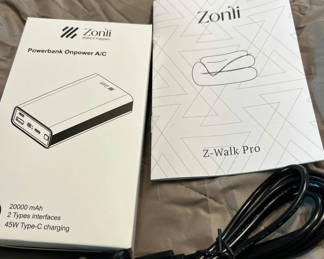 Lot 81: Zoni 20000 mAh Powerbank with Car Charger and Z-Walk Pro Manual and heated blanket