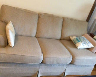 Lot 39: Light gray fabric sofa with two decorative pillows