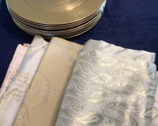 Lot 80: Stack of gold-toned plates with decorative patterned fabrics