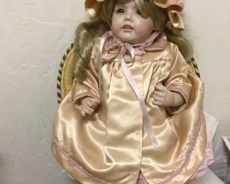 Lot 491: Doll in peach satin dress with bonnet
