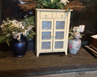Lot 35: White cabinet with blue star-patterned doors surrounded by floral decor