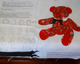 Lot 120: Red floral teddy bear print fabric with sewing instructions; 3 sets