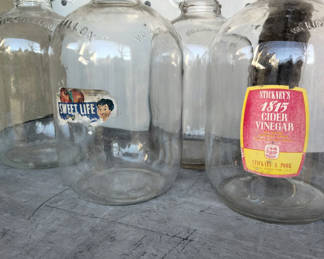 Lot 9: Vintage glass gallon jugs with old labels