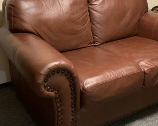 Lot 56: Brown Faux Leather Loveseat, brass stud trim