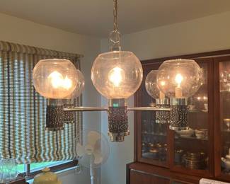$750 vintage Moe Light Gothic Brutalist 6-arm pendant chandelier featuring orb-shaped glass shades and ornate detailing.