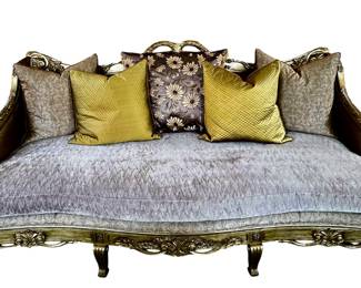 Custom Sofa - Luxurious Fabric, Gold Carved Frame  This custom sofa combines a plush, luxurious fabric with an ornate giltwood frame to create a regal centerpiece for formal living spaces. The carved gold-tone frame features scrolling leaves and floral motifs that echo traditional luxury. Measuring about 100 in long, 41 in deep, and 48 in high, it anchors a room with presence. A five-piece pillow set in coordinating gold and damask patterns adds texture and color to the arrangement.
