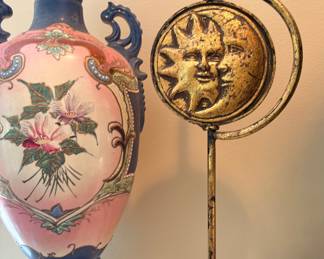 bronze-colored celestial sun and moon candlestick holder