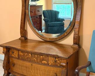 vintage tiger oak princess dresser featuring a large oval tilt mirror and serpentine-front drawers 1890's to early 1900's