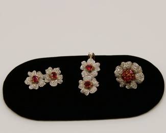 18K gold and Ruby and Diamond demi-parure: These are large, statement pieces. Brooch that could be made into a pair of earrings by a skilled jeweler, and a pendant, and large ring.
