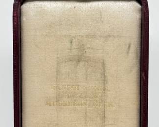 Inside lid of the presentation box with the gold-filled 1904 Muskegon Masonic Past Master badge pin featuring a compass, square, and quadrant design, in original leather presentation box.  Inscribed on the back with "Presented by Lovell Moore Lodge to Geo. H. Armstrong January 4th 1904"