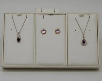 Gold and gemstone pendant necklaces and earrings: An amethyst, diamond and gold pendant necklace, a pair of diamond and amethyst Rose de France on MOP backing earrings, and an amethyst, diamond and gold pendant necklace