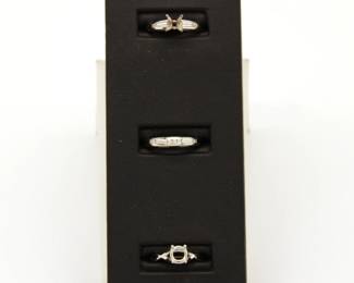 Gold ring settings, some already set with accent diamonds