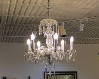 A vintage chandelier featuring clear glass arms and dangling crystal drops