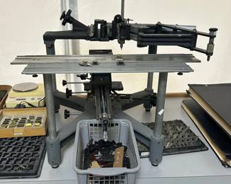 Closer look at the Hermes Industrial Engravograph engraving machine model GTX Super, shown with trays of brass engraving fonts