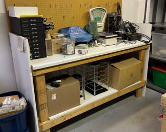 A Vigor Deluxe Engraving Machine, a vintage Pitney Bowes postal scale, Hermes inside ring engraver, Ohaus Harvard Trip Mechanical Balance scale, earring spinners, storage drawers chest,  a two-drawer box full of musical movements, and more, all on a work bench useful for all sorts of crafts and projects and storage 