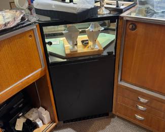 One of a total of four lighted locking corner showcases in black Formica, back view