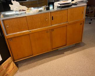 Back view of one of a pair of 5-1/2’ showcases with storage cabinets with sliding doors
