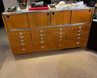 Back view of one of a pair of 5-1/2’ showcases fitted with multiple storage drawers
