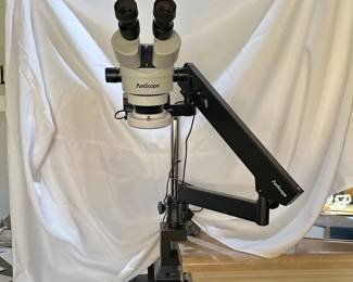 An AmScope stereo zoom microscope on an articulating arm stand