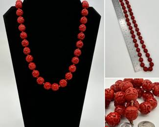 A Chinese 24-inch necklace of carved rich red cinnabar beads