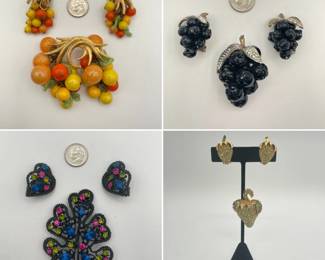 Costume jewelry: A fabulous fruit salad demi-parure featuring clip earrings and brooch, a vintage "Forbidden Fruit" brooch and earrings set featuring clusters of black Lucite grapes accented with black rhinestones and silver-toned leaves, a Japanned metal and colorful rhinestone brooch and earrings set, and a rhinestone and gold tone strawberry form brooch and earrings set