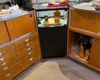 One of a total of four lighted locking corner showcases in black Formica, back view