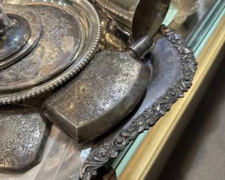 Vintage antique silver-plated items featuring intricate repoussé or engraved floral designs and ornate edges