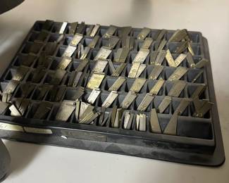 One of several trays of brass engraving fonts