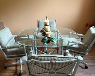 Vintage Patio/sun porch table with rolling chairs. Heavy and sturdy excellent condition 