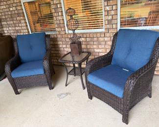 Two outdoor wicker patio chairs, cushions and side table 