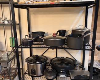 Packed kitchen with crock pots, rice cookers, pots, pans, etc. 