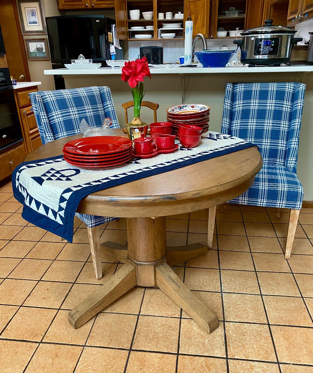 charming round farm table with two upholstered chairs 