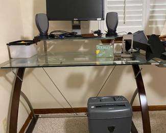 sleek desk, wood accents, glass and metal with curved side piece 