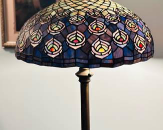 Tiffany-style stained glass floor  lamp featuring a peacock feather motif.
