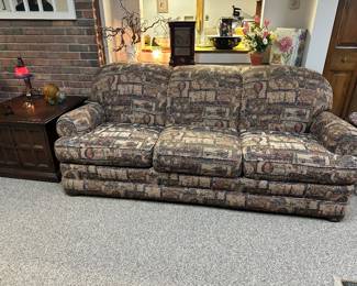  Distinctive sofa with tapestry-style pattern depicting vintage maps, stamps, hot air balloons, and sailing ships