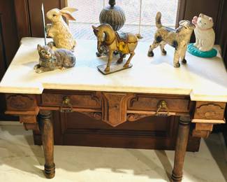 Antique Eastlake or Renaissance Revival walnut console table with a marble top, cast iron Hubley figurines 