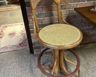 Antique bentwood and cane swivel stool, likely  (circa 1910–1930). These were commonly   used by telephone switchboard operators