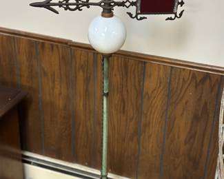 Vintage lightning rod with a white milk glass insulator ball and a directional arrow
