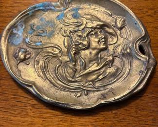 Art Nouveau-style relief made from brass or bronze, often referred to as a "Smoker's Tray